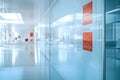 modern office corridor with glass walls displaying documents and bright natural light creating a clean workspace environment Royalty Free Stock Photo