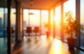 Modern office interior at sunset. Panoramic windows offer city views. Blurred background creates soft focus effect. Light streams Royalty Free Stock Photo