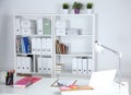 Modern office interior with tables, chairs and bookcases