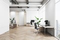 Modern office interior with wooden desks, computers, and a city view, light background, concept of workplace. Royalty Free Stock Photo