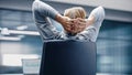 Modern Office: Leaned back on the Chair Businessman Chilling at His Desk. Stock Market Business pe Royalty Free Stock Photo