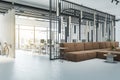 Modern office lobby interior with big couch, city view and daylight. Royalty Free Stock Photo