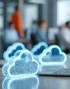 In a modern office, a person operates a laptop featuring a digital cloud icon, representing cloud computing and data Royalty Free Stock Photo