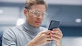 Modern Office: Portrait of Creative Businessman Sitting at His Desk Using Smartphone. Digital Entr Royalty Free Stock Photo