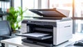 Modern office printer with open lid and paper tray on a white desk Royalty Free Stock Photo