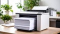 Modern office printer printing documents with stack of paper on desk Royalty Free Stock Photo