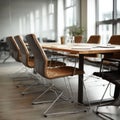Modern office setting featuring empty chairs surrounding a sleek conference table Royalty Free Stock Photo
