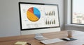 A modern office setup with a computer monitor displaying data visualizations, Royalty Free Stock Photo