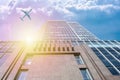 A modern office skyscraper and a white passenger airliner flying over this building Royalty Free Stock Photo