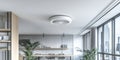Modern office space featuring a circular smoke alarm installed on the ceiling for enhanced safety. Royalty Free Stock Photo