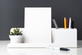 modern office stationery on white table and dark grey wall.pencil, notepad,ruler,pen and pencil box with plant.Mock up paper note Royalty Free Stock Photo