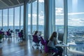 Modern Office Workers Collaborate, Using Computers and Enjoying Panoramic City View from Floor-to-Ceiling Windows, High-Rise Royalty Free Stock Photo