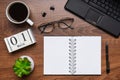 Modern office workplace with laptop keyboard, coffee cup, smart phone, stationery and plant. Date 01 March on wooden block Royalty Free Stock Photo