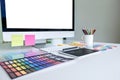 Modern office workplace with tablet, Graphic designer and color swatch samples at workplace Royalty Free Stock Photo