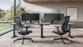 modern minimalistic office workspace with dual computer monitors ergonomic chairs and natural light from large window overlooking Royalty Free Stock Photo