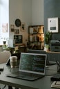 Modern Office Workspace Featuring Laptop Displaying Programming Code Royalty Free Stock Photo