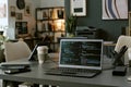 Modern Office Workspace Featuring Laptop Displaying Programming Code on Screen Royalty Free Stock Photo