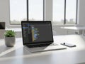 Modern office workspace with laptop and coding software on screen in bright environment Royalty Free Stock Photo