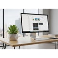 Modern office workspace with a large computer monitor displaying a coding Royalty Free Stock Photo