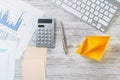 Modern office workspace with yellow paper ship