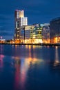 Modern offices and apartment buildings in docklands, reflected in blurred Liffey River at dusk, Dublin, Ireland Royalty Free Stock Photo