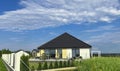 Modern one storey house in Poland. Backyard view through the garden fence Royalty Free Stock Photo