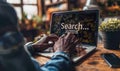 Modern Online Search Concept with a User Typing in a Search Bar on a Laptop Screen Symbolizing Information Access