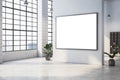 Modern open office space with large windows, plants, and a blank framed display on a white wall for branding or advertising. 3D Royalty Free Stock Photo