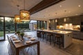 Modern open plan kitchen with dining table and glowing lamps Royalty Free Stock Photo