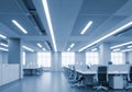 Modern open plan office interior with bright fluorescent lighting Royalty Free Stock Photo