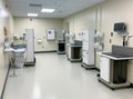Modern operating room with various medical equipment, surgical tables, monitors and cabinets. The image is suitable for use in
