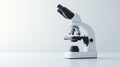 Modern optical microscope on a white surface with a minimalistic background