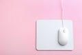 Modern optical wired mouse and white pad on background, top view. Space for text Royalty Free Stock Photo