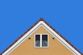 Modern orange house gable roof design wall with clear blue sky background Royalty Free Stock Photo