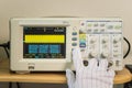 Modern oscilloscope, man`s hand adjusting wave signals, closeup