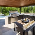 A modern outdoor kitchen with a built-in grill, a spacious countertop, and a comfortable dining area with a pergola for shade1, Royalty Free Stock Photo