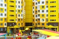 A modern outdoor playground in the courtyard of a building. Colorful children\'s swings and slides for recreation and games Royalty Free Stock Photo