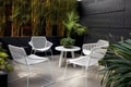 modern outdoor seating area with sleek metal and plastic furniture