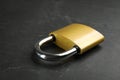 Modern padlock on black table, closeup. Safety and protection