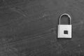 Modern padlock on black table, top view. Space for text