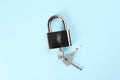 Modern padlock with keys on light blue background, top view Royalty Free Stock Photo