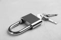 Modern padlock with keys on light table, closeup Royalty Free Stock Photo