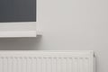 Modern panel radiator under window indoors. Heating system Royalty Free Stock Photo