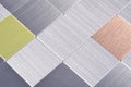 Modern panel with shiny silver and colored metal plates, grid wall Royalty Free Stock Photo