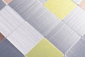 Modern panel with shiny silver and colored metal plates, grid wall Royalty Free Stock Photo