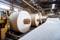 Modern paper mill factory with machines turning wood pulp into rolls of paper for various uses Royalty Free Stock Photo