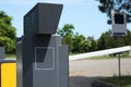 Modern parking meter outdoors on sunny day, closeup. Space for text Royalty Free Stock Photo
