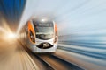 Modern passenger high-speed electric train moving fast along terminal platform. Motion blur