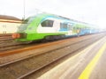 Modern passenger train en route. Worker inspects the railway line. High-speed train with motion blur. Train at the railway station Royalty Free Stock Photo