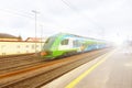 Modern passenger train en route. Worker inspects the railway line. High-speed train with motion blur. Train at the railway station Royalty Free Stock Photo